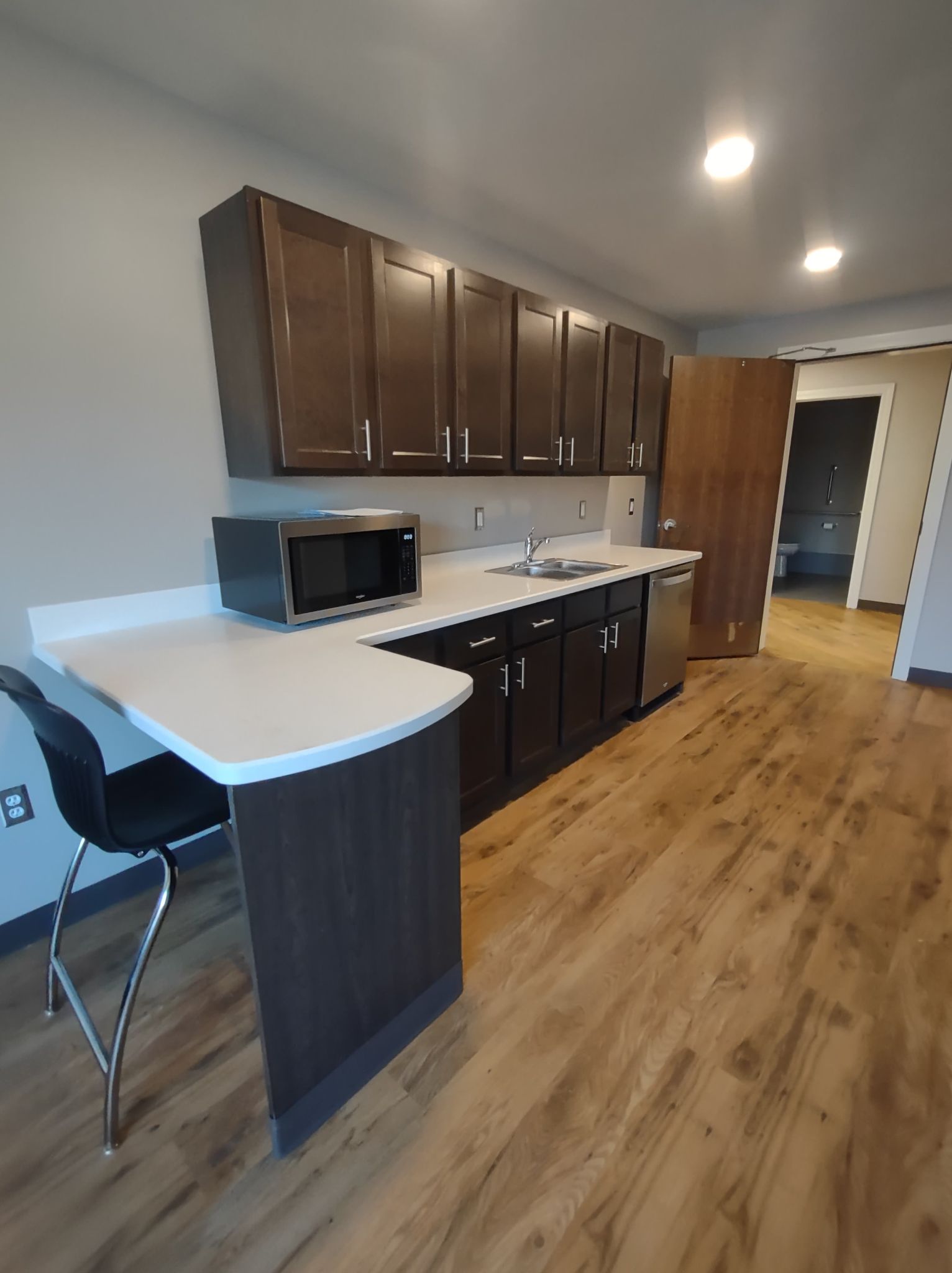 kitchenette with microwave and cabinets